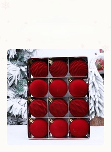 Close-up of 12-piece red flocked Christmas ornaments with textured and glossy finishes
