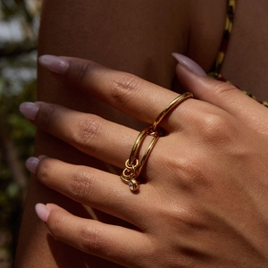 Detailed macro of 18K gold-plated double-layer link ring with a sparkling zircon pendant