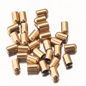 Macro shot of gold stainless steel end caps for DIY jewelry making and cord endings