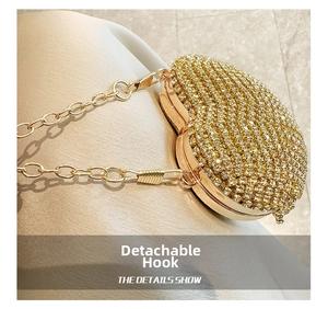 Close-up of the detachable gold chain hook on a luxury heart-shaped rhinestone evening bag