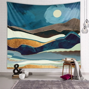 Modern abstract mountain tapestry displayed over a cozy living room seating area
