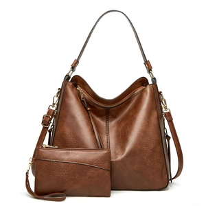 Brown faux leather tote bag and matching pouch with gold hardware in casual retro style