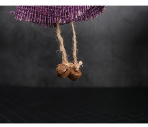 Detail of hanging rusty metal bells and purple burlap cloth for Halloween decoration