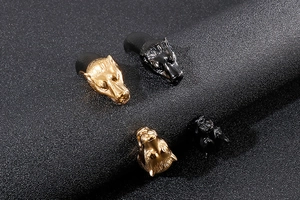 Detailed view of punk wolf head bracelets in gold and black stainless steel finishes
