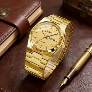 Detail of elegant gold steel watch dial with day-date display next to leather notebook