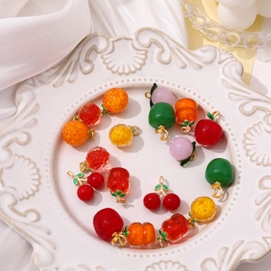 Handmade fruit glass charms with gold loops including cherry, apple, and peach shapes