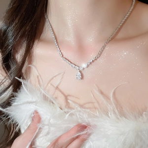 Close-up of elegant teardrop zircon pendant necklace on a model's collarbone
