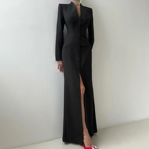 Detail of elegant black slim fit dress with row buttons and sexy high slit hemline