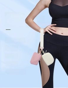 Detail of waterproof nylon wristlet set featuring pink and beige mini pouches for storage