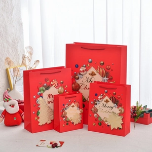 Red Christmas gift bag set with Merry Christmas text in various sizes for holiday packaging