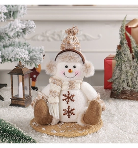 Détail d'un bonhomme de neige de Noël avec bonnet en tricot marron et broderie de flocon