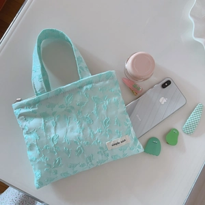 Mint green floral jacquard handbag with texture detail and simple wish logo tag