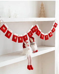 Close-up of Merry Christmas felt sequin stockings banner and plush gnome holiday figurines