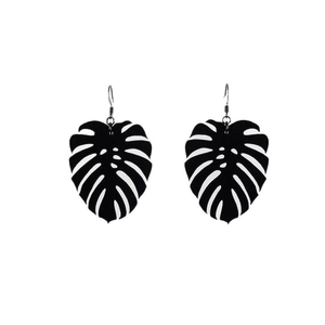 Minimalist black monstera leaf dangle earrings with metallic hooks on white background