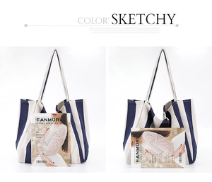 Detail of a large capacity blue and white striped canvas tote bag with reinforced handles