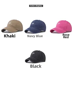 Detail of washed cotton baseball caps with embroidered logos in khaki, navy, pink, and black