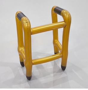 Detailed side view of inflatable golden walking frame party prop with four-leg structure