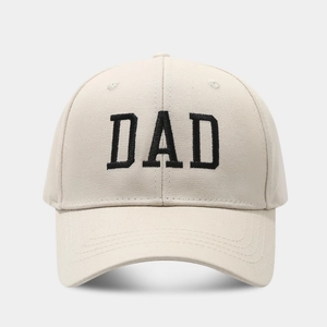Primer plano del bordado negro DAD en una gorra de béisbol de algodón beige con visera