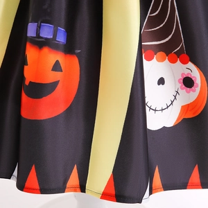 Detail of Halloween dress fabric featuring pumpkins and sugar skulls on black polyester