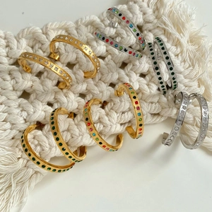 Chic gold and silver C-shaped hoop earrings with colorful gemstones on macrame back