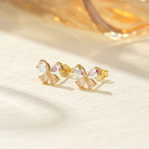 Macro shot of gold butterfly earrings with iridescent gems and S925 silver studs