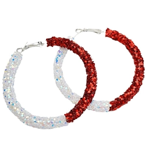 Detail of large glittery hoop earrings with a split red and white sequined finish