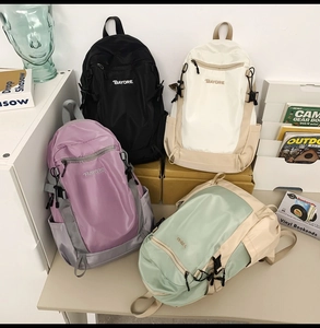 Multiple color options of waterproof nylon backpacks including black, beige, and purple
