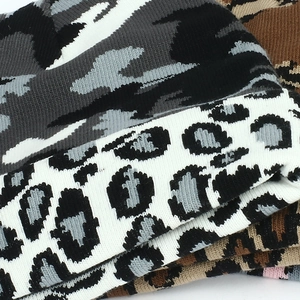 Knitted beanie hat featuring camouflage and leopard patterns for winter warmth