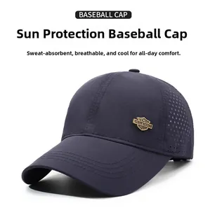 Detail of dark blue baseball cap with laser-cut holes and classic metal badge