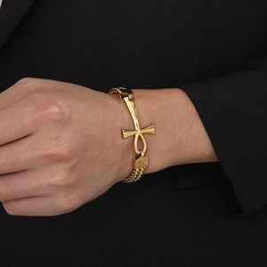 Detailed close-up of golden Ankh cross bracelet with braided stainless steel chains