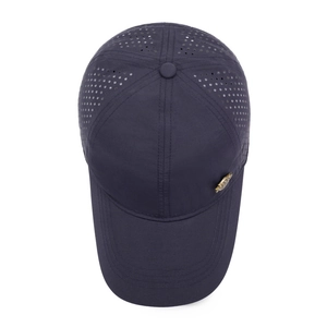 Navy blue breathable baseball cap with laser-cut side vents and a vintage metal badge