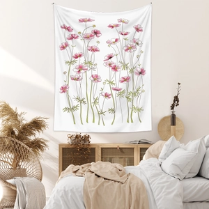 Detailed view of bohemian floral tapestry with pink cosmos hanging on white bedroom wall
