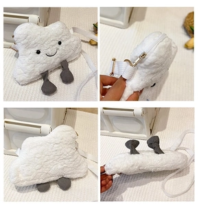 Macro view showing soft cloud plush bag texture, embroidery smile and metal zipper detail