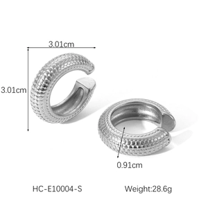 Macro shot of silver hollow ear clips with textured scale pattern and size measurements