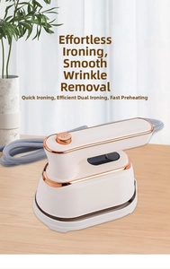 Detail of portable pearl white steam iron with rose gold trim on a wooden surface