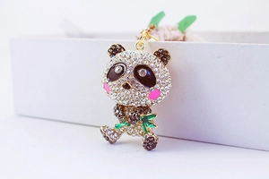 Detailed macro view of crystal-encrusted panda keychain with green enamel bamboo detail