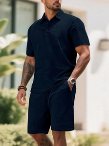 Detail showing navy waffle texture fabric and three-button collar on men's polo set