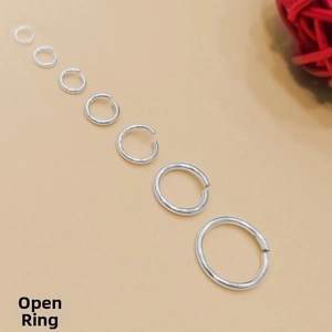 Macro detail of seven S925 sterling silver open jump rings in various sizes for DIY jewelry