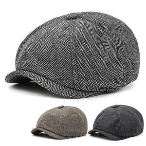 Detailed close-up showing textured herringbone tweed patterns of retro newsboy caps in 3 colors