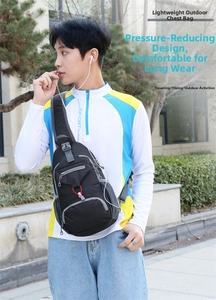 Detail of black nylon outdoor chest bag featuring multi-pocket storage and durable zippers