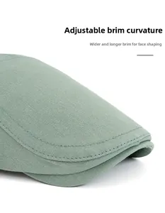 Detail of grey-green cotton beret showing reinforced stitching and foldable brim