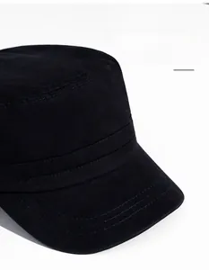 Detail of black cotton twill flat top military cap with wide brim and stitched seams