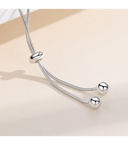 Macro detail of S925 sterling silver snake chain bracelet with adjustable slider bead