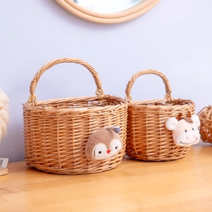 Handwoven willow wall hanging storage baskets with cute animal patches in a home setting