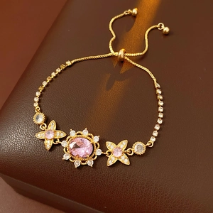 Detail of vintage gold bracelet with oval pink gemstones and adjustable sliding clasp