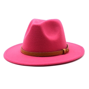 Close-up of rose pink fedora hat featuring a brown snakeskin band and gold buckle