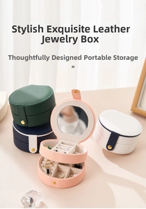 Detail view of round leather travel jewelry cases in multiple colors with built-in mirrors
