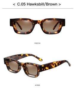 Close-up of square hawksbill sunglasses with brown gradient lenses and metal hinges