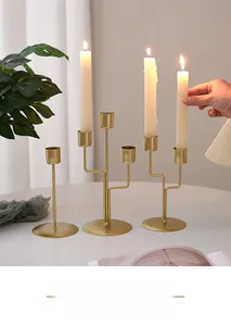 Close-up of matte gold geometric iron candlesticks in a cozy candlelit dining setting