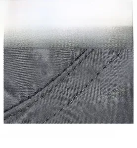 Detail shot of grey high-density mesh fabric with durable double-needle stitching on the hat